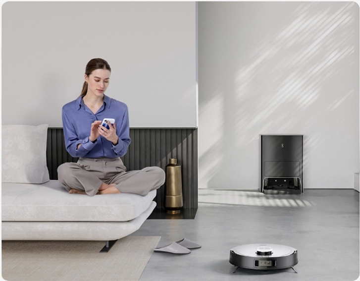 Person with device and robot vacuum